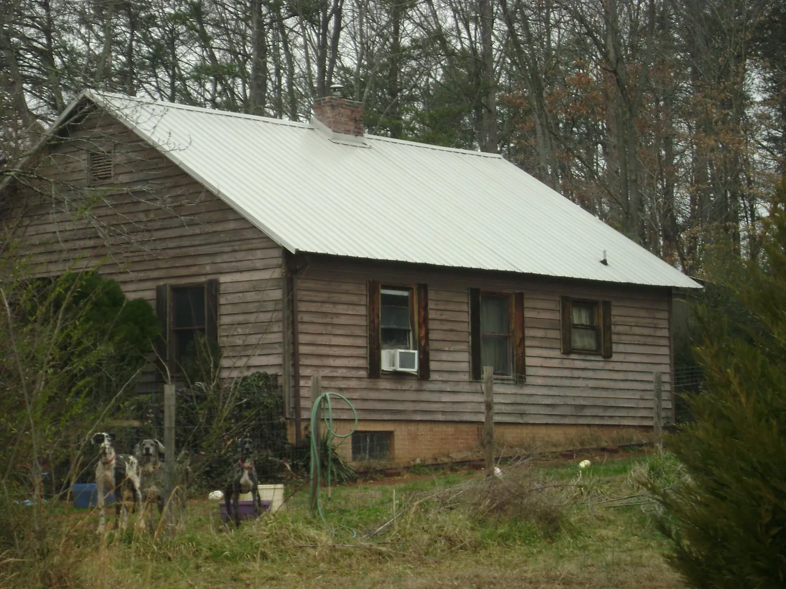 White metal roof on an old wood sided farmhouse, from a Metal Roof Installation job in Montague